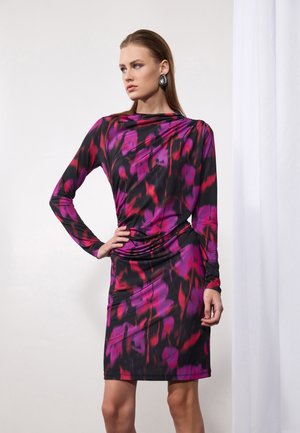 Black dress with long sleeves, featuring a bold pink and purple abstract pattern, draped neckline, and fitted silhouette. Smooth, stretchy fabric.