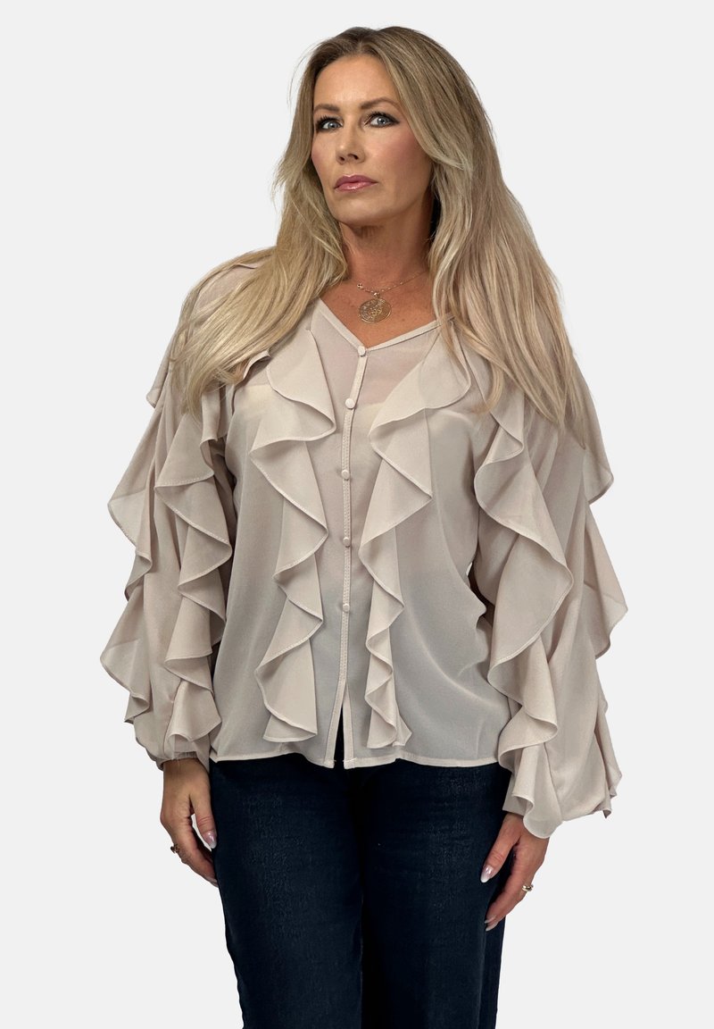Helles beiges Blusenkleid mit kaskadierenden Rüschen, transparentem Stoff und V-Ausschnitt. Hat Knöpfe auf der Vorderseite und lange Rüschensäume.