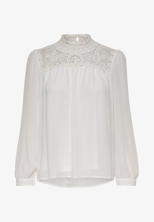 Biała bluzka z długimi rękawami, z koronkową wstawką na górze i plisowanym materiałem, zapewniająca lekkość i zwiewną fakturę.