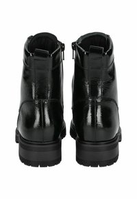 Zwarte leren enkellaarsjes met een glanzende afwerking, voorzien van een rits aan de zijkant en een chunky rubberen zool.