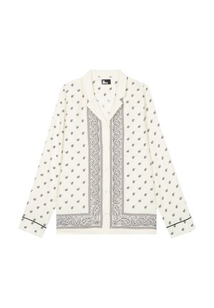 Hvid langærmet skjorte med knapper foran, dekoreret med sorte paisley-mønstre og kantdesigns, med klassisk krave og sort piping på ærmernes manchetter.