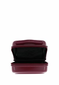 Valigia compatta rigida color amaranto aperta che mostra l'interno in tessuto nero con tasca con zip.