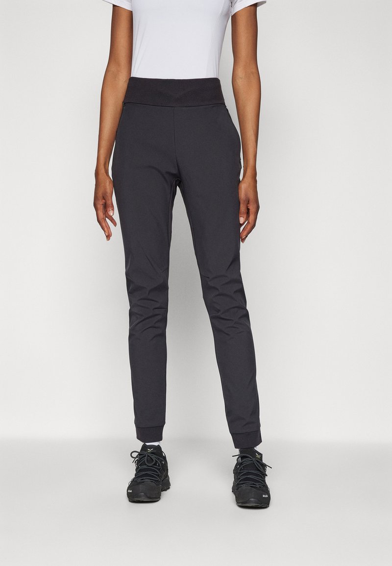 Svarte treningsbukser med en tettsittende design, elastisk midje og mansjetter ved leggen. Laget av et glatt, lett og elastisk stoff.