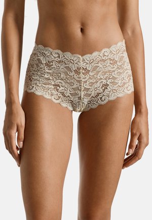 Lace boyshorts with a scalloped waistline in a light beige color, featuring floral patterns and a sheer texture.