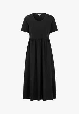 Zwarte katoenen jurk met korte mouwen, ronde halslijn en een empire taille die overgaat in een volle, vloeiende rok. Glad textuur.