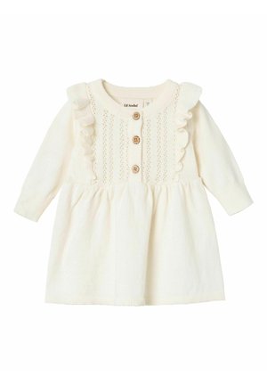 Kleid in cremefarbener Strickoptik mit langen Ärmeln, Rüschen am Ausschnitt, Knopfverschluss und strukturiertem Oberteil mit Lochmuster.