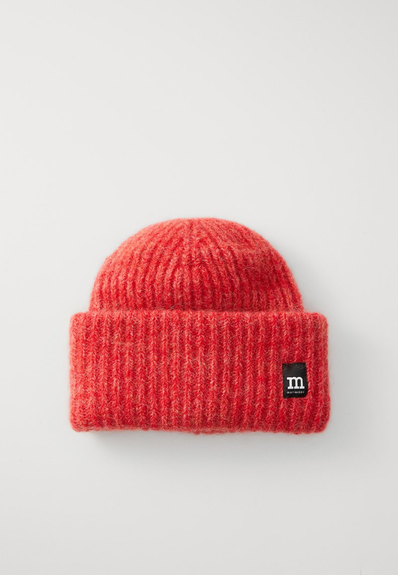Red knitted beanie with a ribbed texture. Features a folded cuff and a small black label with a white letter "m" on the side.