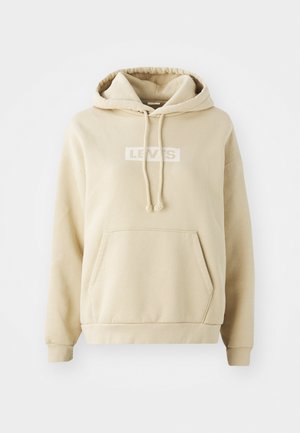 Beige huppari, jossa on etupuolen kenguru-tasku, nyörihuppu ja valkoinen "LEVI's"-logo tulostettuna rintaan. Pehmeä kankaan texture.