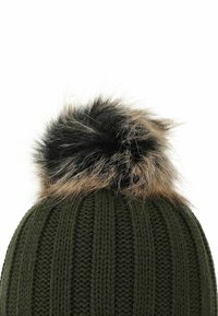 Green knitted beanie with a ribbed texture and a large faux fur pom pom on top, featuring beige and black color accents.
