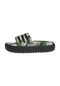 Green and black slide sandal with a palm leaf pattern, textured strap, and a thick black rubber sole featuring a wavy design.