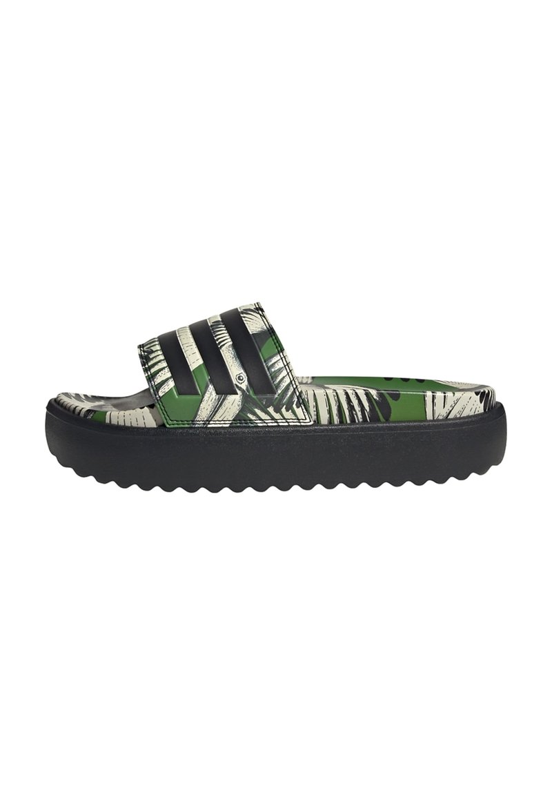 Green and black slide sandal with a palm leaf pattern, textured strap, and a thick black rubber sole featuring a wavy design.