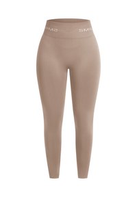 Legging beige taille haute sans couture avec une ceinture élastique portant le mot "SMILE" en lettres blanches.