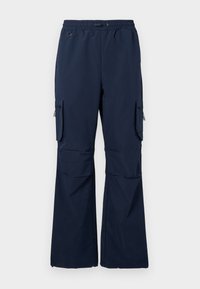 Navy cargo pants made of lightweight fabric featuring a drawstring waist, two side pockets, and zippered cargo pockets on both legs.