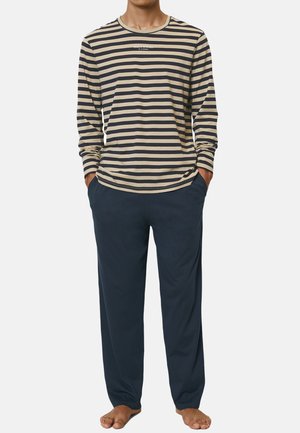 Long-sleeve striped shirt in beige and navy with a crew neckline, paired with dark blue pants, both made from soft fabric. Relaxed fit.
