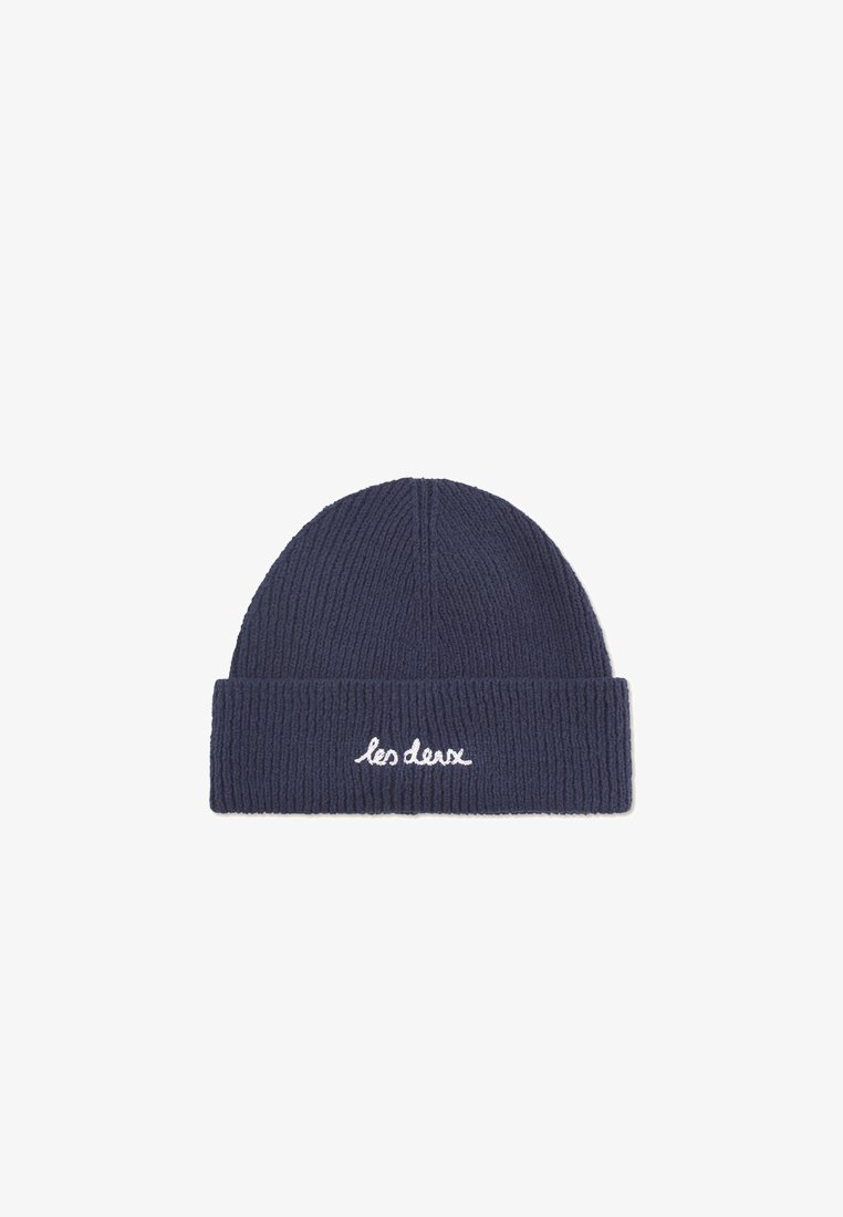 Navy blue knitted beanie with ribbed texture and a rolled cuff. Features white embroidered text "les deux" on the front.