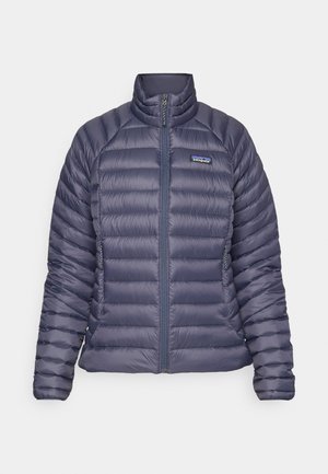 Navy blue puffer jacket with a stand collar, zippered front, and horizontal quilted pattern. Features side pockets and a logo on the chest.