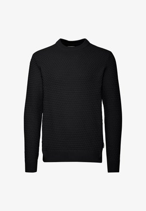 Melnas džemperis ar teksturētu, quilted rakstu. Garas piedurknes, apaļa kakla izgriezums un ribotās aproces un apakšmalas. Vienkāršs, bez izšuvumiem dizains.
