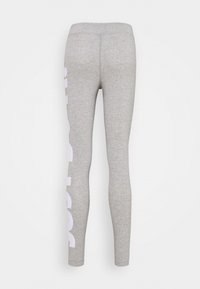 Grå leggings i mjukt, stretchigt material. Har en vit logotypgrafik ned längs vänster ben. Sittande design med hög midja.