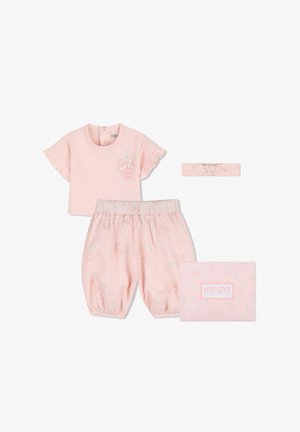 Light pink baby outfit with ruffled short sleeve top, elastic waist shorts with subtle print, matching headband, and branded gift box.