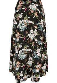 Sort med blomsterprint og elastisk midje, med store hvite og pastellfargede blomster, grønne blader og tropiske detaljer. Løs og flytende design.