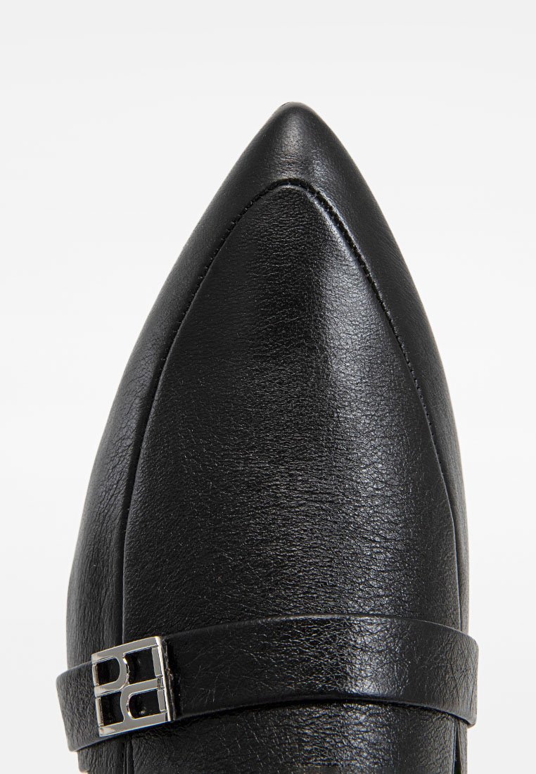 Czarne buty na szpilce z wąskim noskiem, z teksturowanej skórzanej cholewki, z metalowym akcentem i wąskim paskiem. Projekt jest nowoczesny i elegancki.