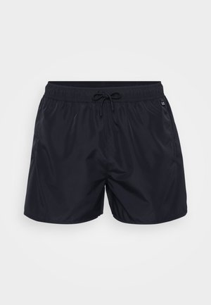 Svart badetights laget av lett stoff, med elastisk midjebånd og snor, samt sidelommer. Enkel og allsidig design.