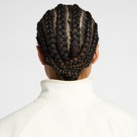 Close-up view of braided hair in a symmetrical design, showcasing multiple fine braids in a dark color against a light fleece collar.