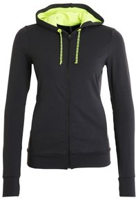 Haut à zip noir avec une capuche intérieure vert fluo, présentant des cordons de serrage contrastés et une coupe ajustée. Texture de tissu douce et lisse.