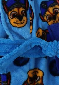 Blue fleece bathrobe featuring a repeating cartoon dog design with a smile and a hat, secured with a matching tie belt. Soft texture.