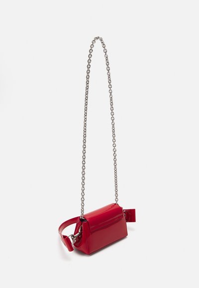 Red patent leather crossbody bag with a silver chain strap, rectangular shape, and a front flap closure. Smooth texture, minimal hardware.