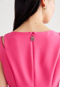 Fuchsia dress with a smooth texture and a high neckline, featuring a zipper pull with "HUGO" in silver-toned metal on the back.