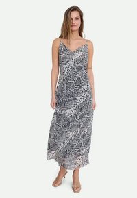 Maxi dress with thin straps in a black and white abstract print. Lightweight fabric with a flowing design and a V-neckline.