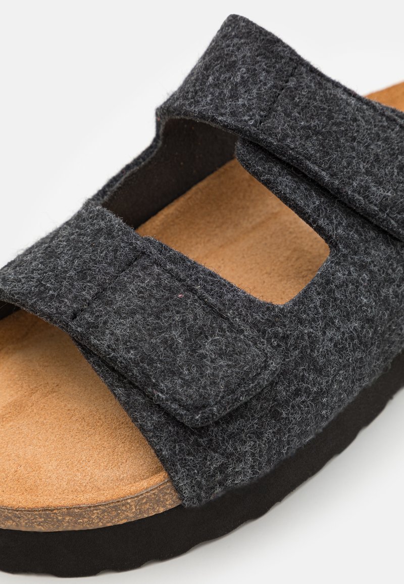 Szare klapki z podszewką, z dwiema regulowanymi ramiączkami, korkową wkładką i czarną gumową podeszwą. Posiadają gładką, teksturowaną powierzchnię.