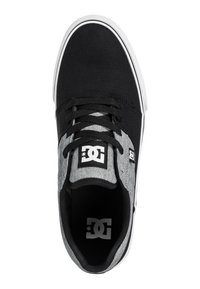 Black and gray skate shoe with canvas material, round toe, laces, white sole, and prominent logo patch on the tongue.