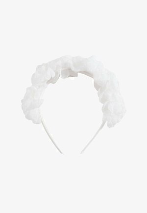 Bandeau en tissu blanc orné de détails floraux translucides et froncés le long du dessus.