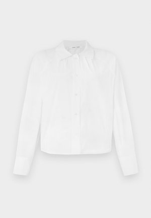 White button-up shirt with a collar, long sleeves, and a slightly cropped design. Made from a smooth, lightweight fabric.