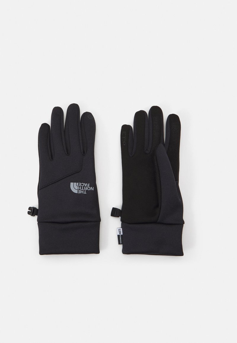 Sorte hansker med et elegant design, laget av et mykt materiale, med teksturert grep på håndflaten, og en logo på håndleddsområdet.