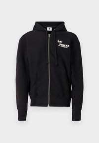 Čierna mikina na zips z bavlny. Má predné logo, kapucňu so stiahnutím na šnúrku, predné vrecká a rebrované manžety a spodný lem. Hladká textúra.