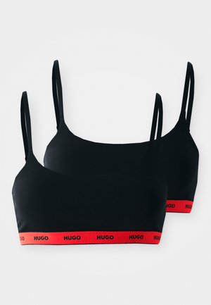 Must musträtik -komplekt mustades toonides, õhukeste rihmade ja punase bändiga, millel on "HUGO" logo. Sujuv kangas, minimaalne disain, sobib igapäevaseks kandmiseks.