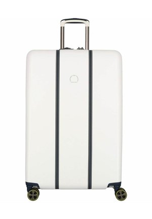 White hard-shell suitcase with black vertical stripes. Features a telescopic handle and four multi-directional wheels. Sturdy design.
