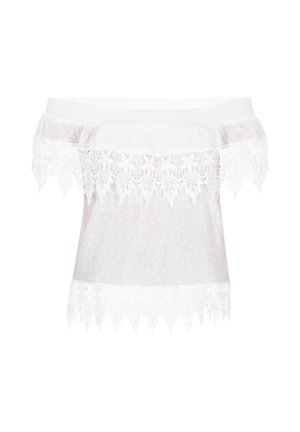 Blusa blanca sin mangas hecha de tejido ligero, con lunares y un borde de encaje en el cuello y el dobladillo. Textura suave.