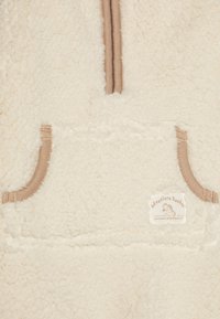 Off-White Fleece-Pullover mit einer strukturierten Oberfläche, featuring einen halben Reißverschluss am Kragen, beige Akzenten und einer Fronttasche mit einem Markenlabel.