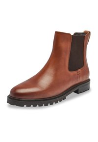Botín Chelsea de cuero marrón con paneles laterales elásticos, punta redondeada y suela de goma texturizada, con una lengüeta en la parte trasera para facilitar su uso.