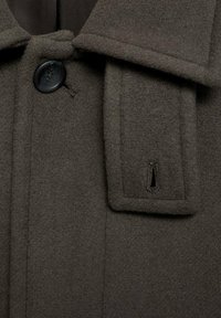 Brown wool coat, featuring a notched collar, a large dark button closure, and a vertical slot for accents on the left side near the collar.