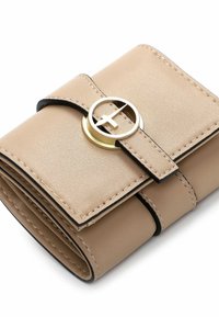 Beige leather wallet with a circular gold-tone clasp, featuring black trim and visible stitching. Compact design with a smooth texture.