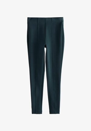 Donkergroene legging gemaakt van gladde, rekbare stof. Bevat verticale naden voor design en een brede, elastische tailleband. Geen zichtbare sluitingen.