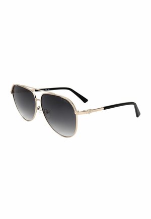 Occhiali da sole stile aviator con montatura in metallo dorato, lenti nere sfumate, terminali delle aste neri e piccoli dettagli decorativi sui bordi della montatura.