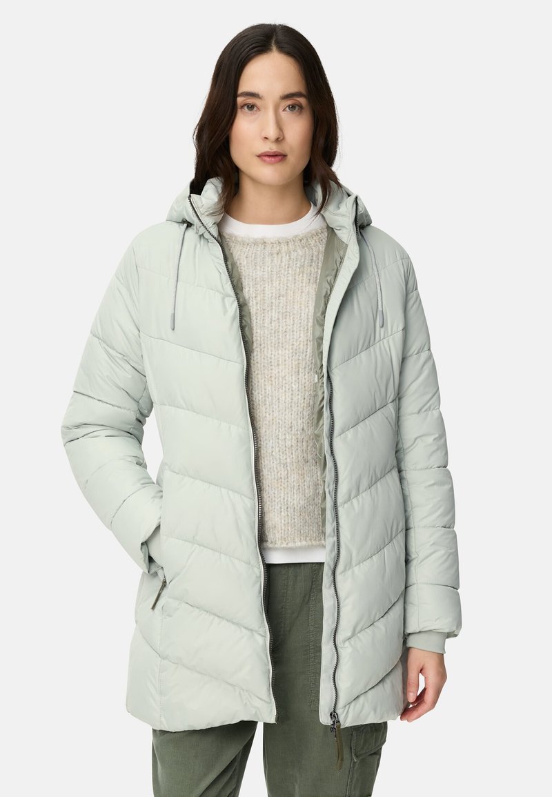 Light green quilted jacket with a hood, full zipper, and side pockets. Worn over a beige knitted sweater and green pants. Smooth texture.