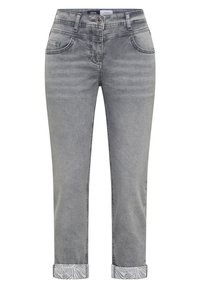 Jean en denim gris avec des revers roulés montrant un motif de feuilles blanc et gris, bouton devant, fermeture éclair et design cinq poches.