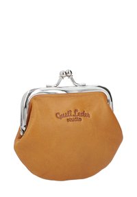 Tan leather coin purse with a silver metal clasp, rounded shape, embossed branding on the front, and smooth texture.